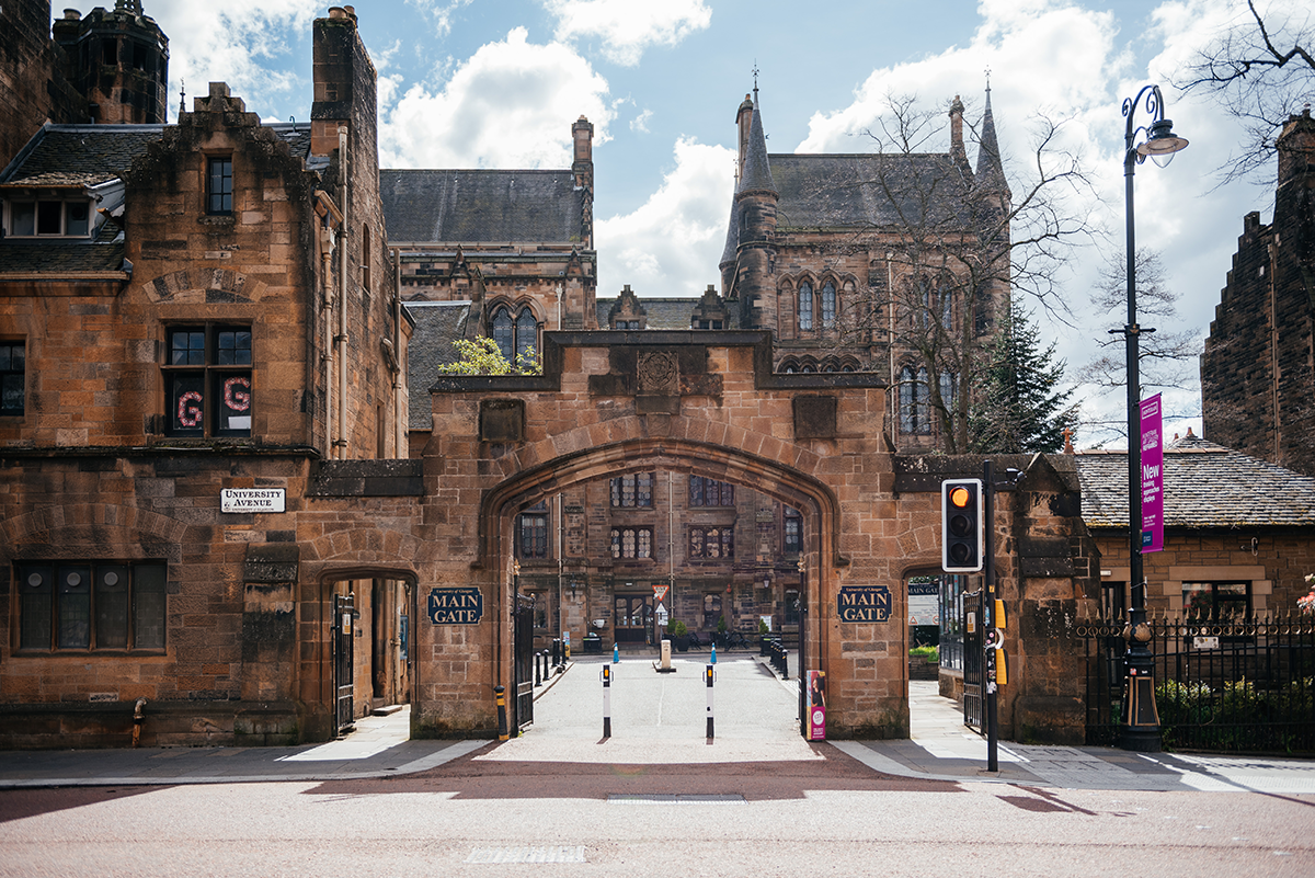 Main Gate of the University of Glasgow photographed at midday under bright sunlight.